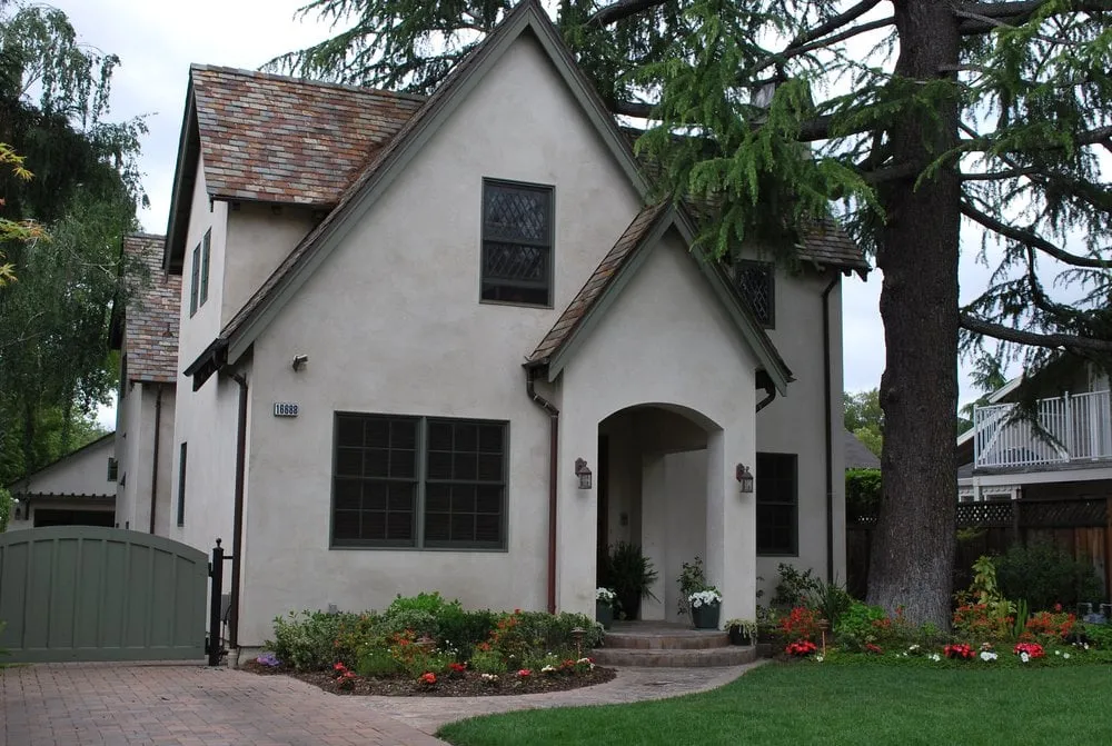 Aluminum-clad windows on a stucco house under a shake roof